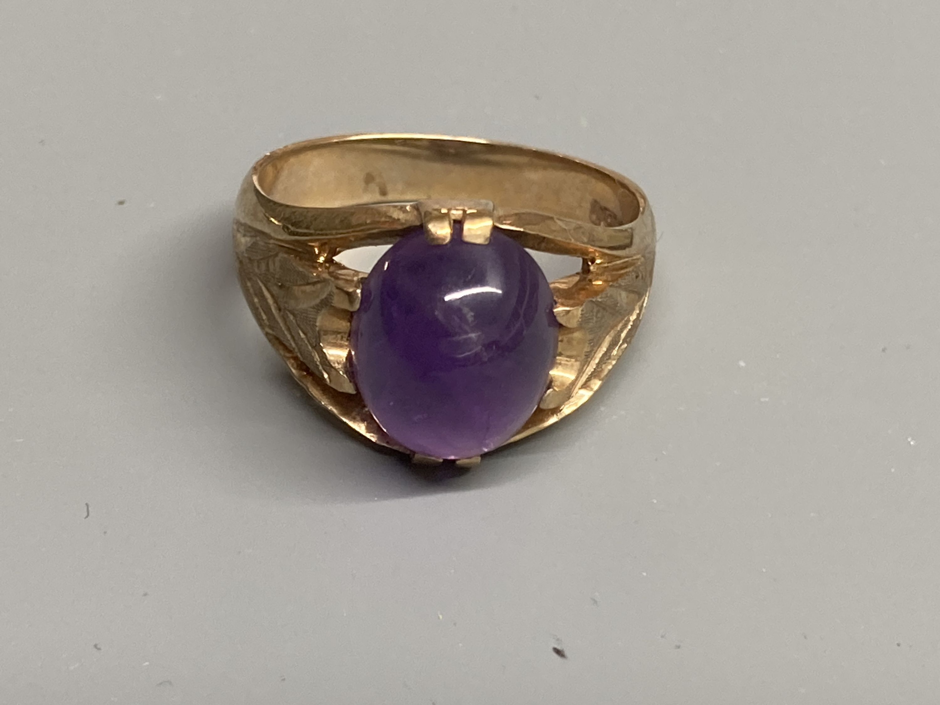 Two modern 9ct gold and cabochon amethyst set dress rings, sizes Q/R & T
